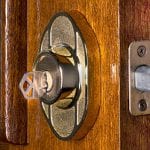 Deadbolt lock on mahogany front door.